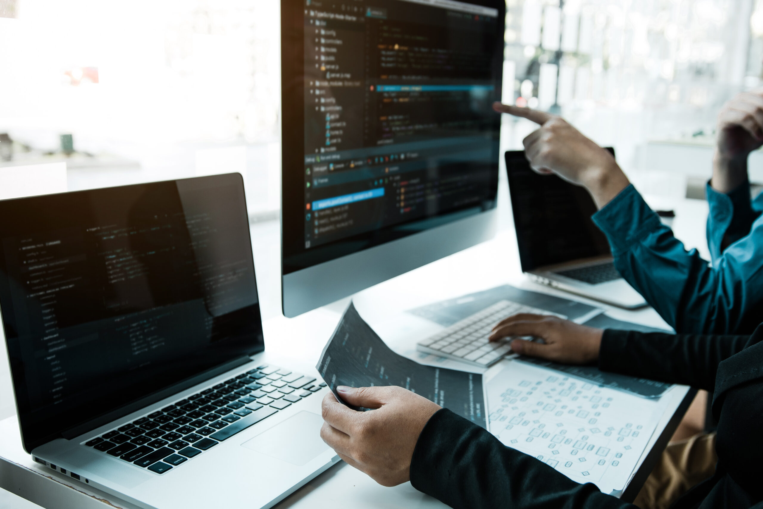 Two asian team working development of programming and encryption technology website design programmers on desk in office.